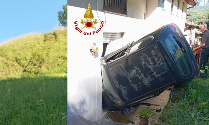 Auto in sosta si muove da sola lungo una scarpata e finisce incastrata nella finestra di una casa